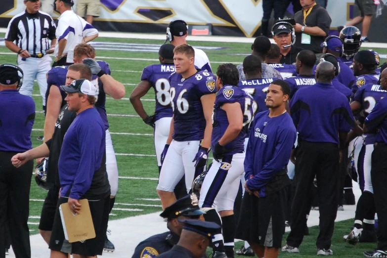 a group of football players standing around each other