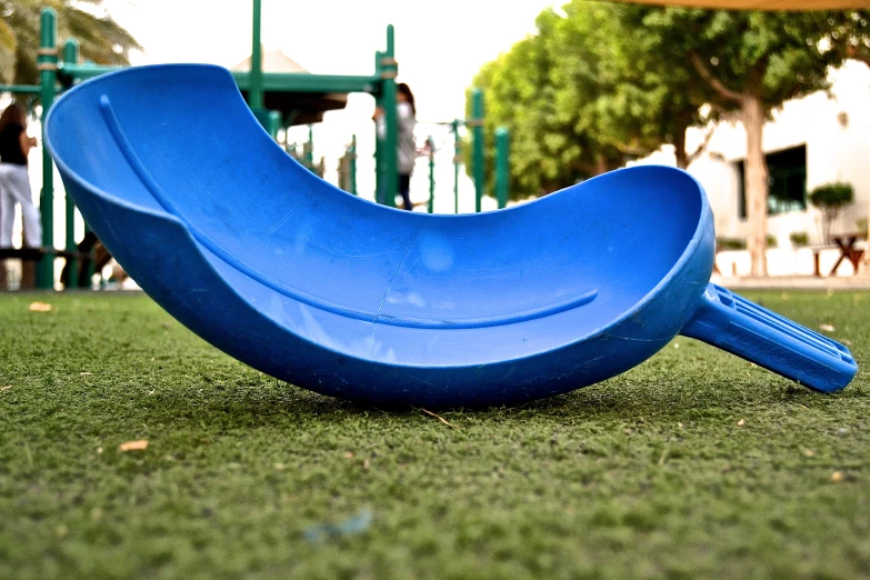 a blue slide in the middle of grass