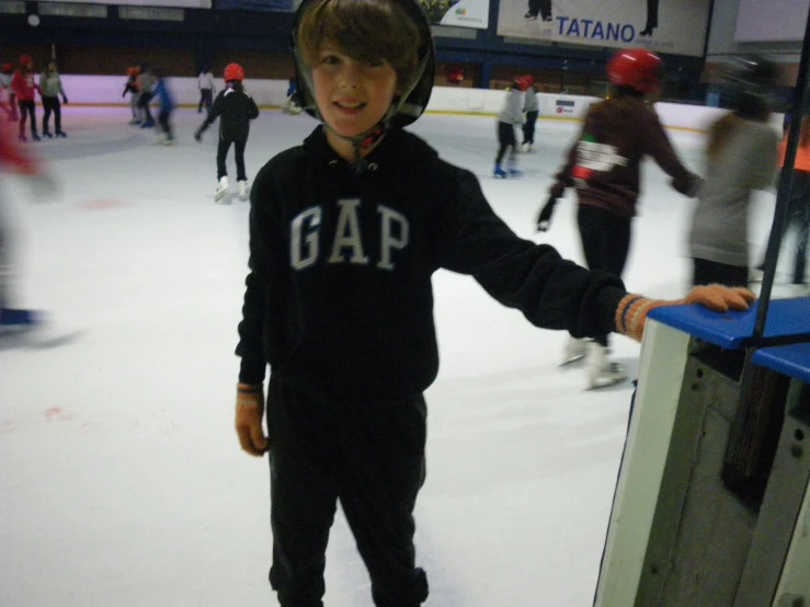 a child standing on an ice rink in front of a machine