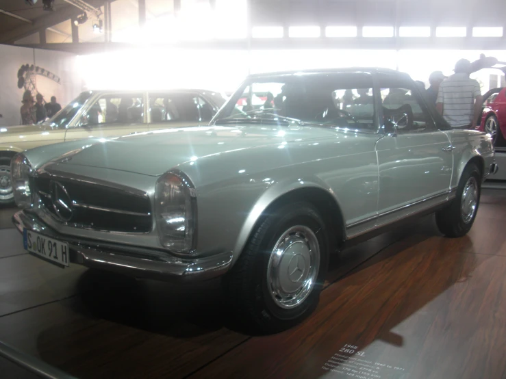 a museum exhibit of old cars at a car show