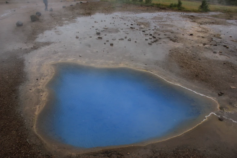 the blue pool is in the mud on the ground