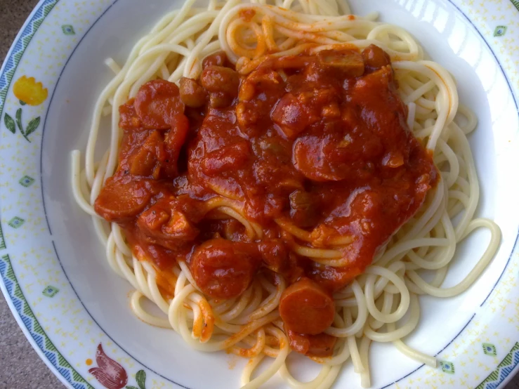 spaghetti with sauce is served on a plate