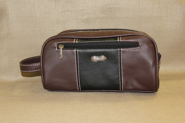 a brown and black leather bag on a white background