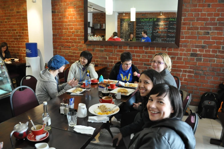 a group of people eating at the table