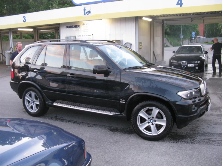 a black suv with the hood up