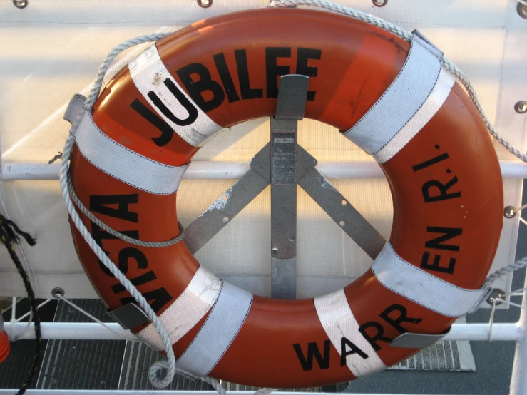an orange life preserver and peace sign on a ship