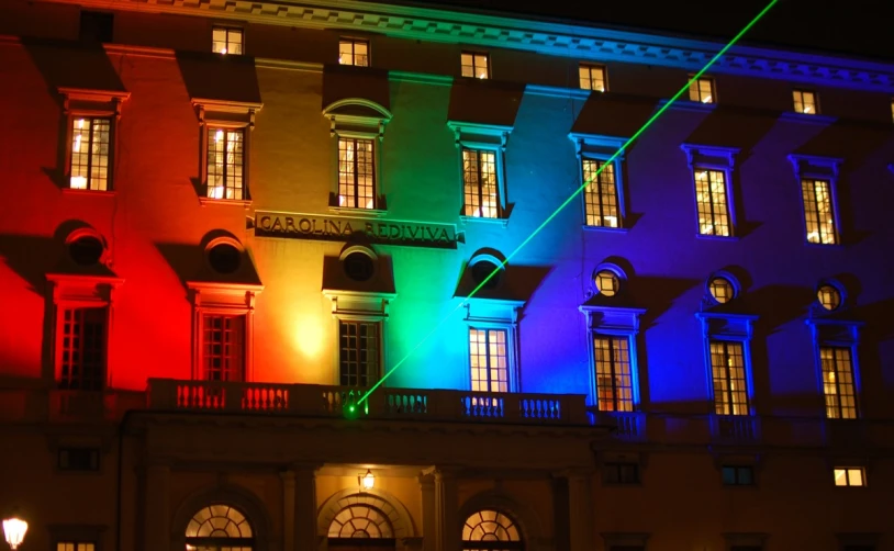 an illuminated building lit up at night with windows