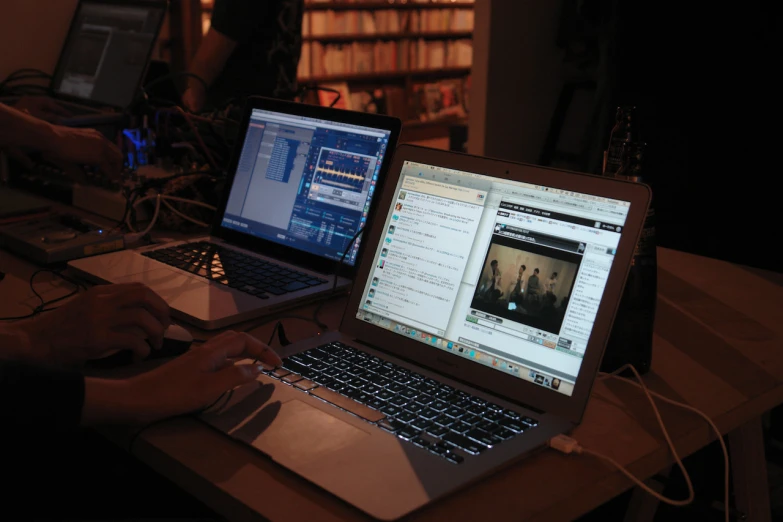 two laptops sitting on a table in front of a liry