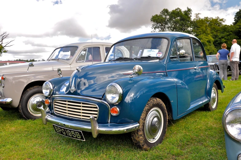 two classic car displayed at show next to each other