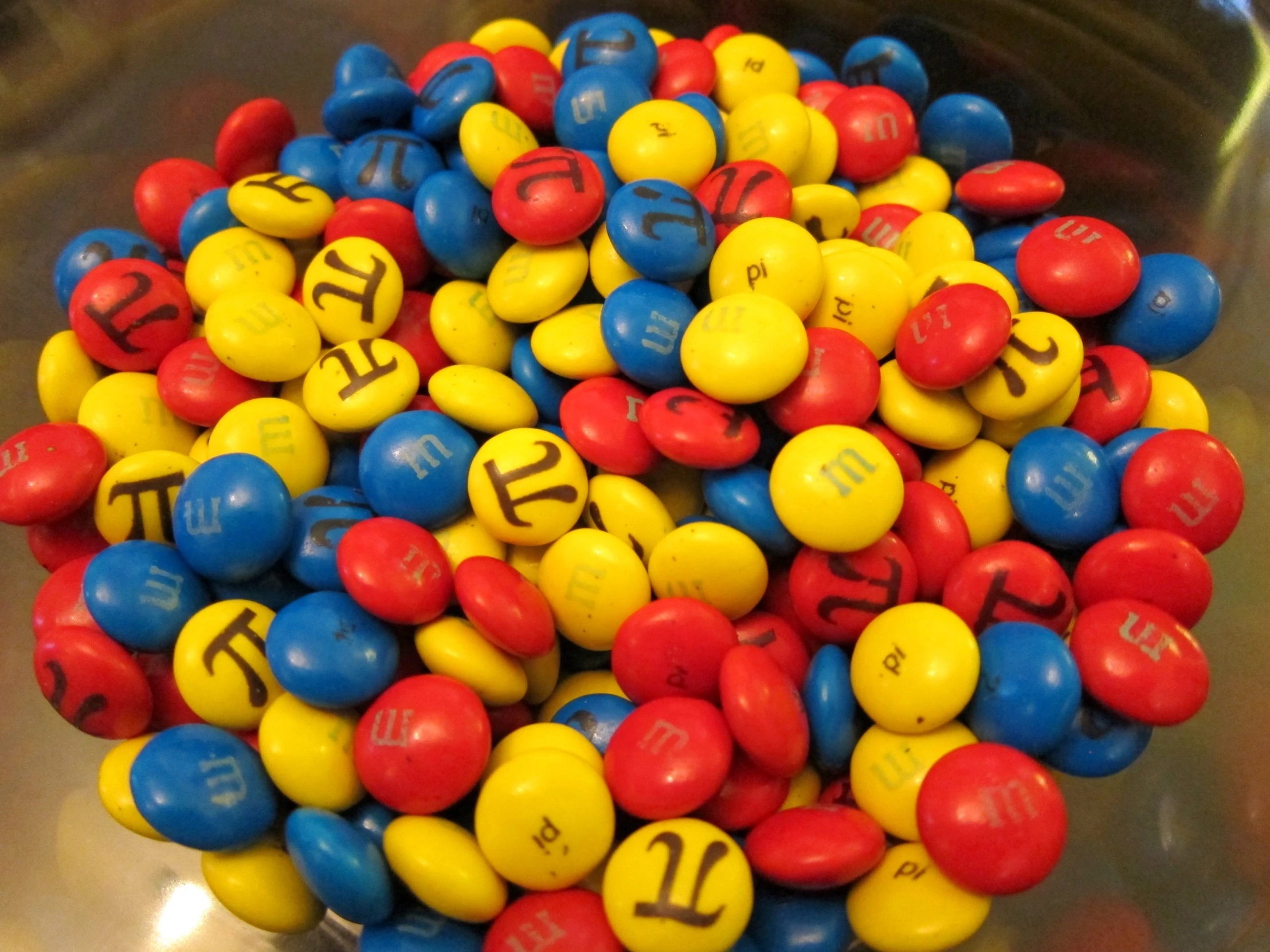 colored candies in a silver container on display