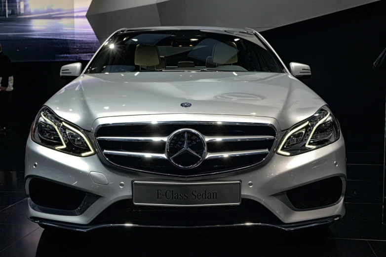 white mercedes cla is displayed on the floor