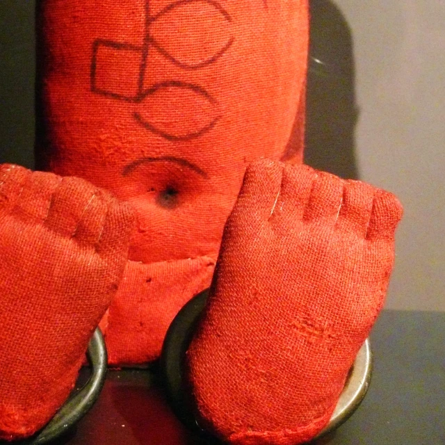 the orange glove is near a pair of metal 
