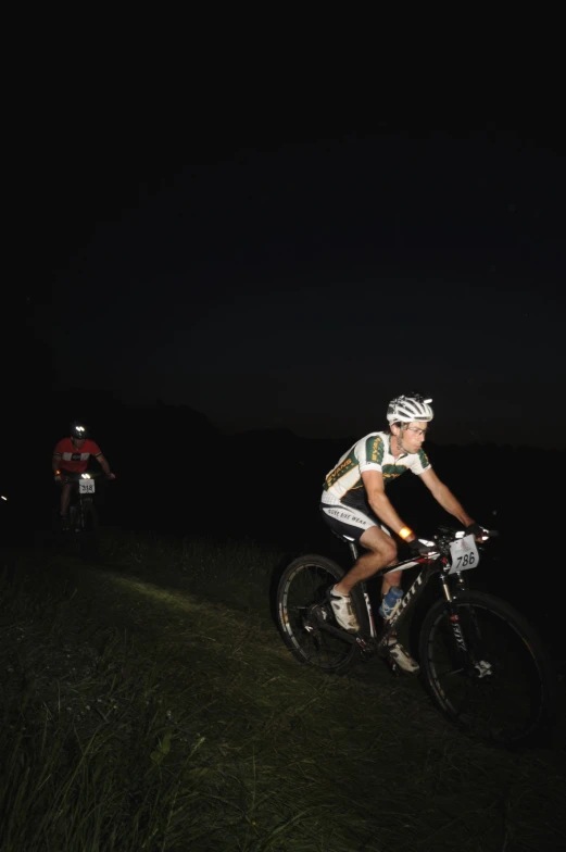 a man on a bike with grass in front of him