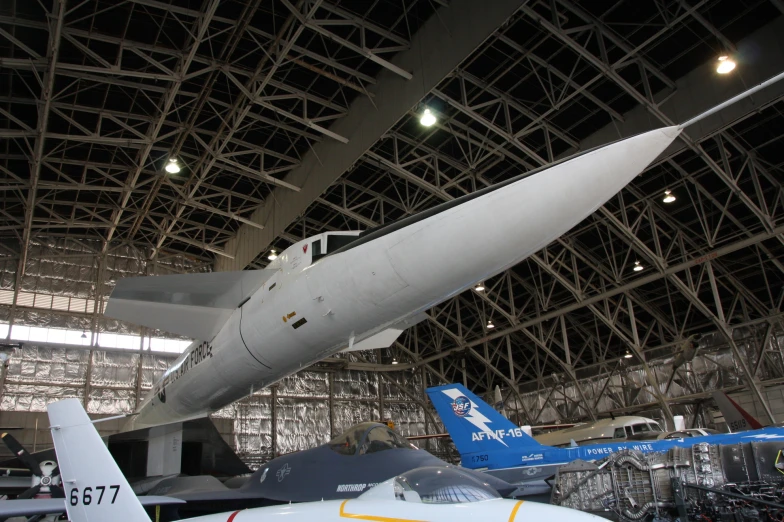two jets sitting in an airplane hanger on display