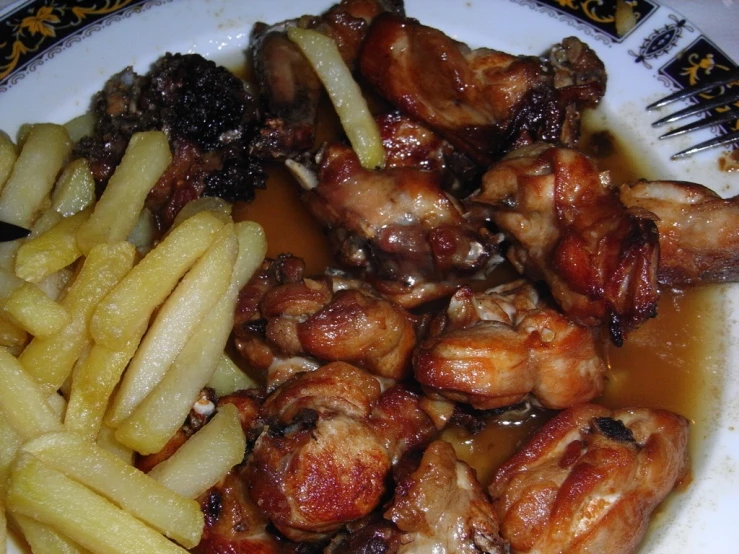 an image of chicken wings with fries in gravy