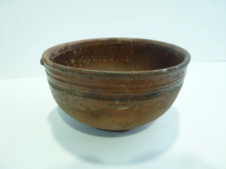 a big old brown bowl sitting on a table