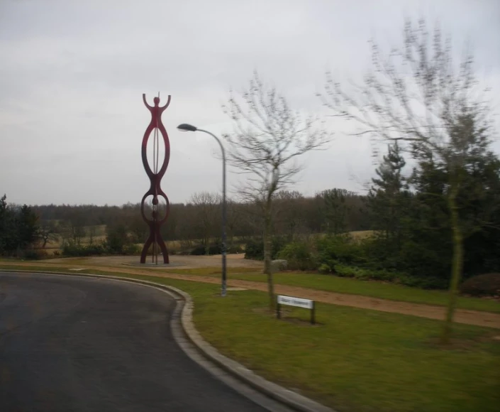 a large statue with an individual statue in front of it