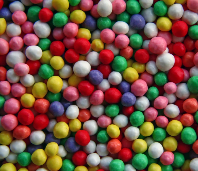 a bunch of candy balls are shown in close up