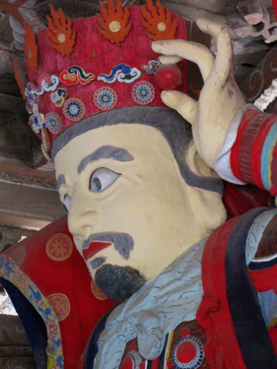 a sculpture of a man dressed in chinese clothes