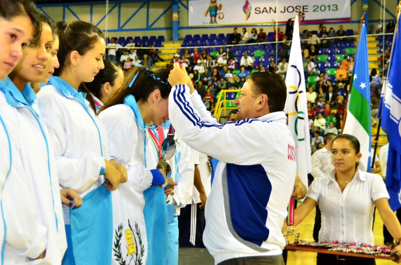 a group of women with flags are on a stage