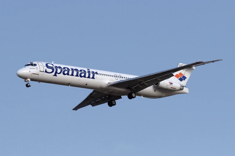 an airplane flying against a blue sky