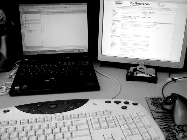 two computers sit on top of a desk