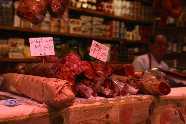 meat at an open market in france, showing some sausages