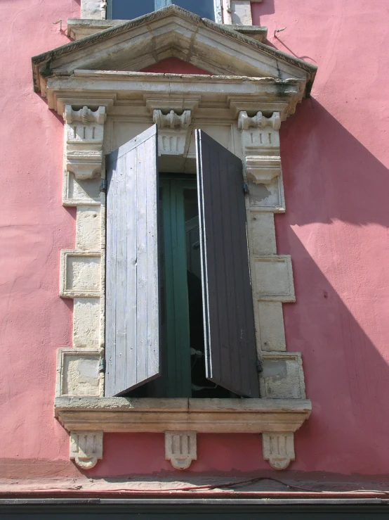 a building with an open window and a black door