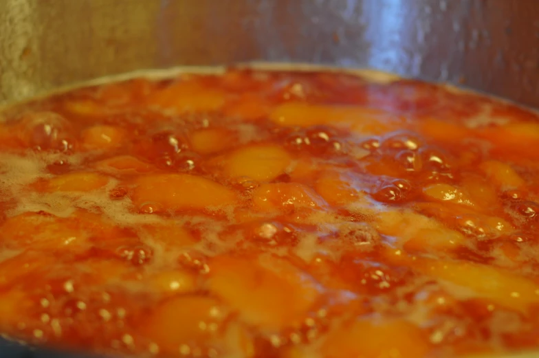 a close up of a pot of food cooking on a stove