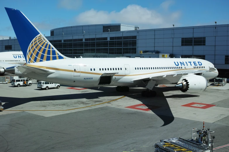 two airplanes parked outside an airport terminal