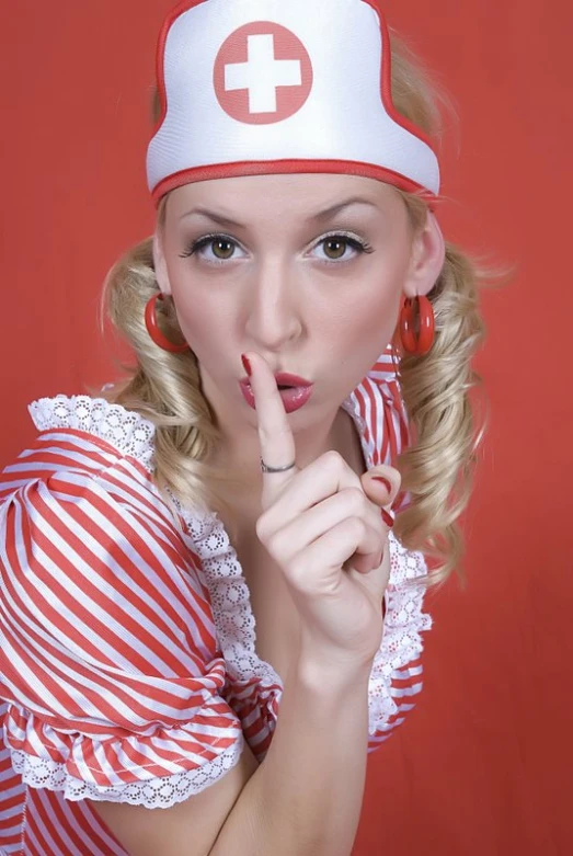 the woman is dressed as a nurse in a red and white striped dress