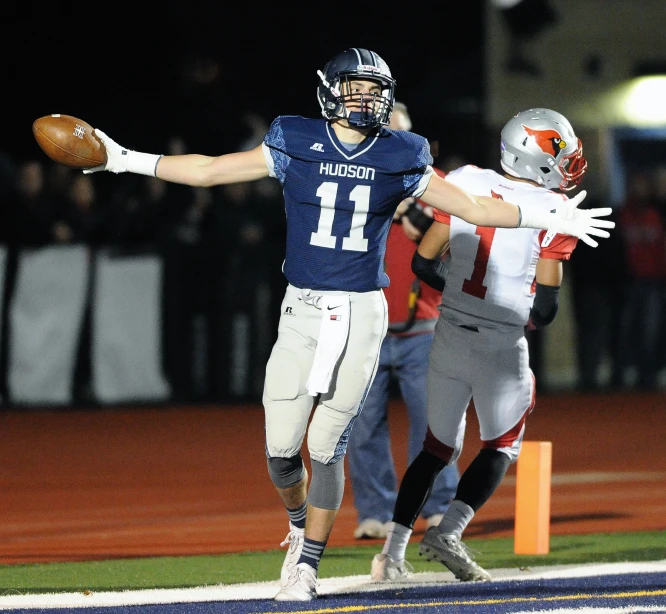 a football player throwing a ball to another man