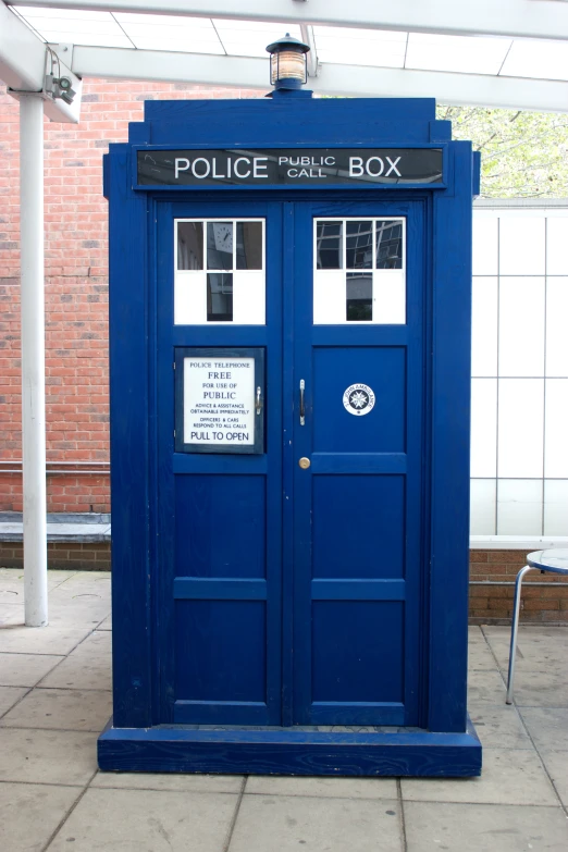 a blue police box on the side of a street