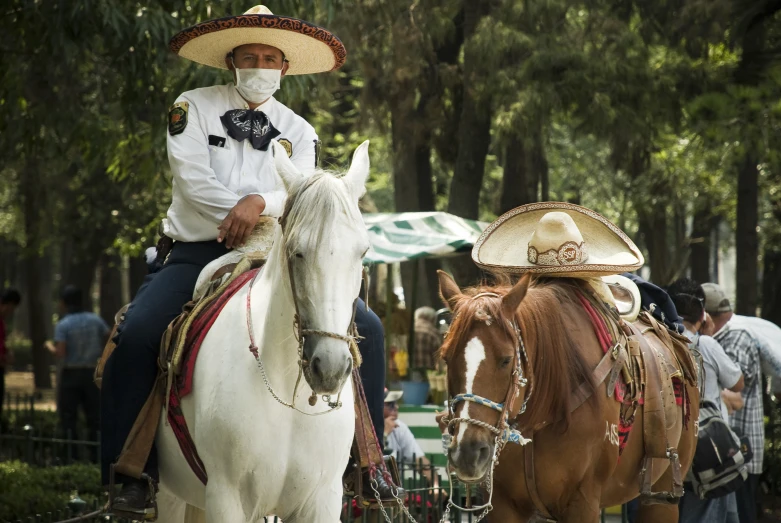 people sit on their horses in uniforms at an outdoor event