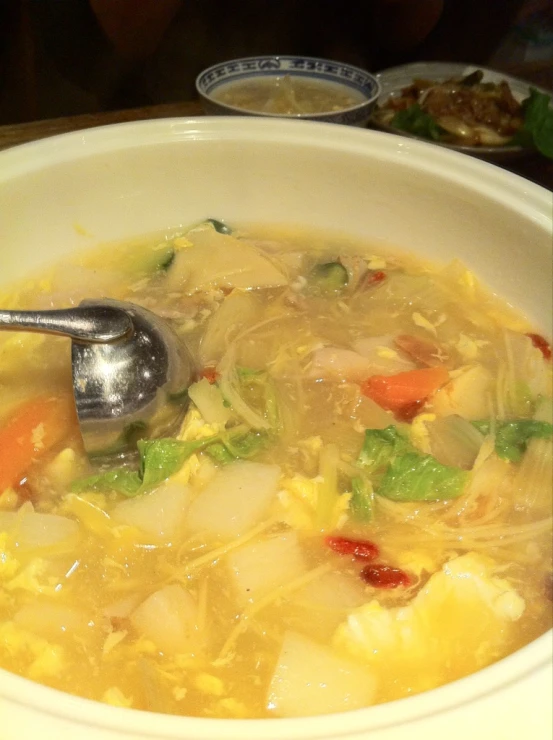 there is a spoon in a bowl filled with food