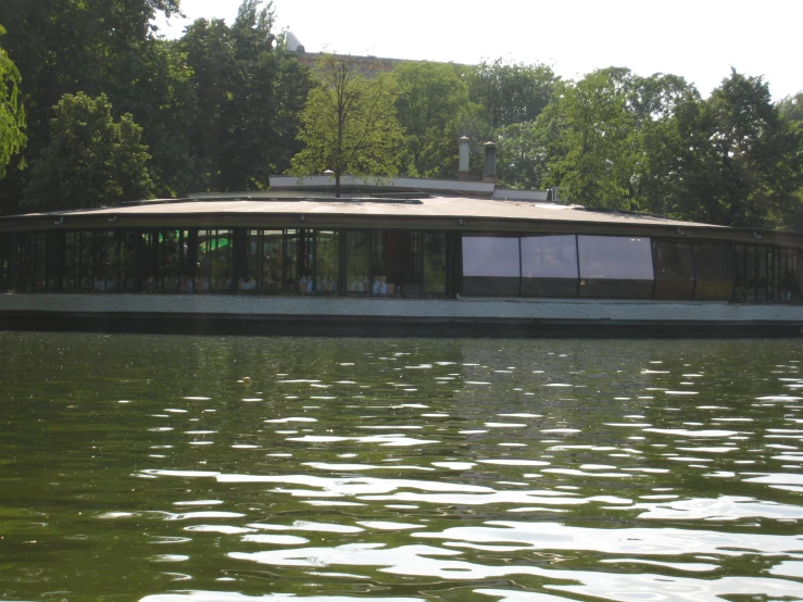 a house boat floating on top of a lake