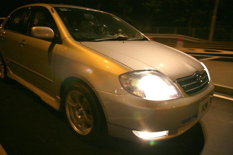 a yellow car is shown in the dark