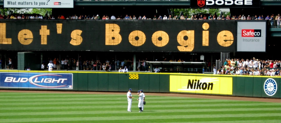 people watching a baseball game in a stadium