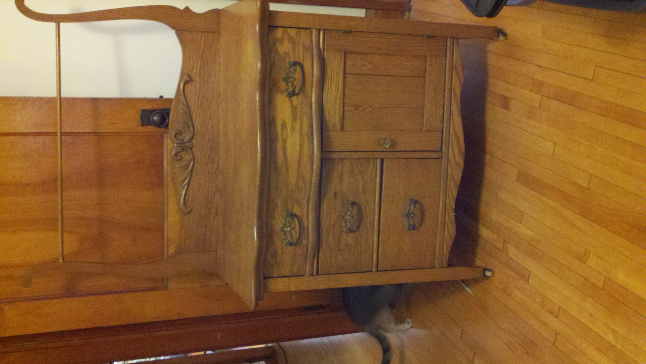 an old dresser with wooden drawers, mirror and handbag