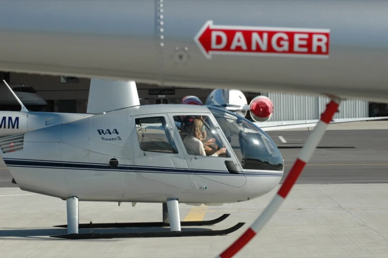 a white plane with the word danger on it