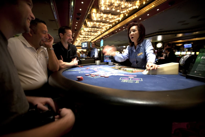 several people playing cards in a casino table