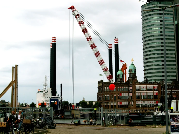 a crane sits in front of a brick building