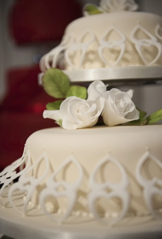 a white triple layer cake sitting on top of a table