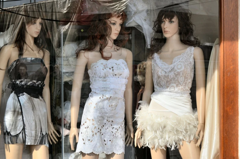 a window display with a couple of mannequins in front