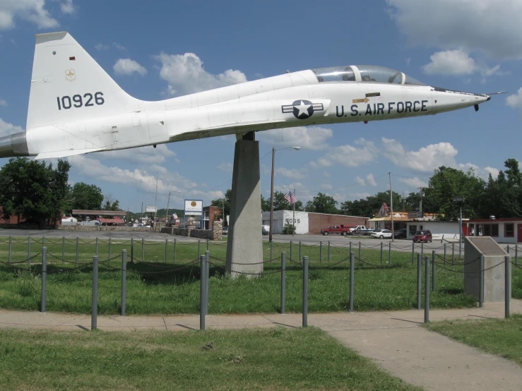 an old model military airplane sits on display