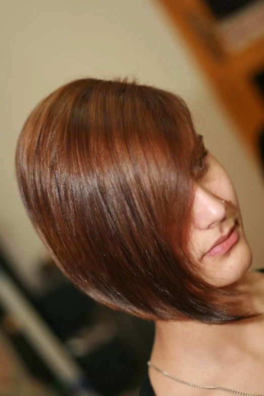 a close - up view of a woman with red hair looking off into the distance