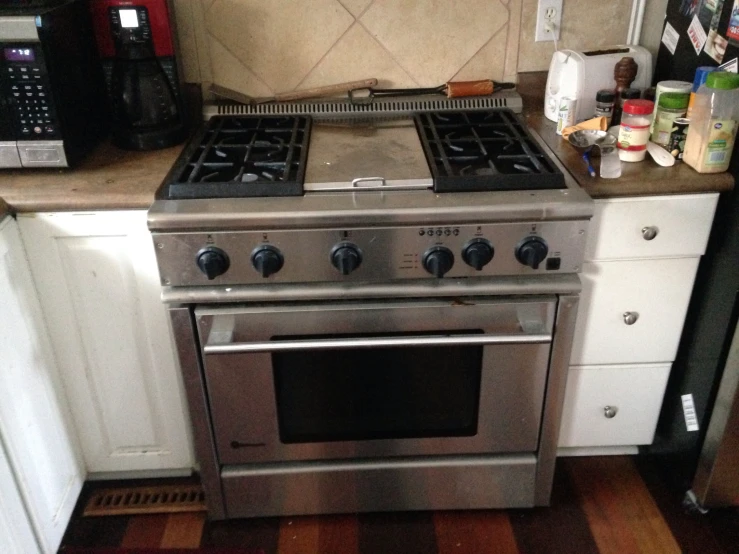 a kitchen scene with focus on the oven and coffee maker