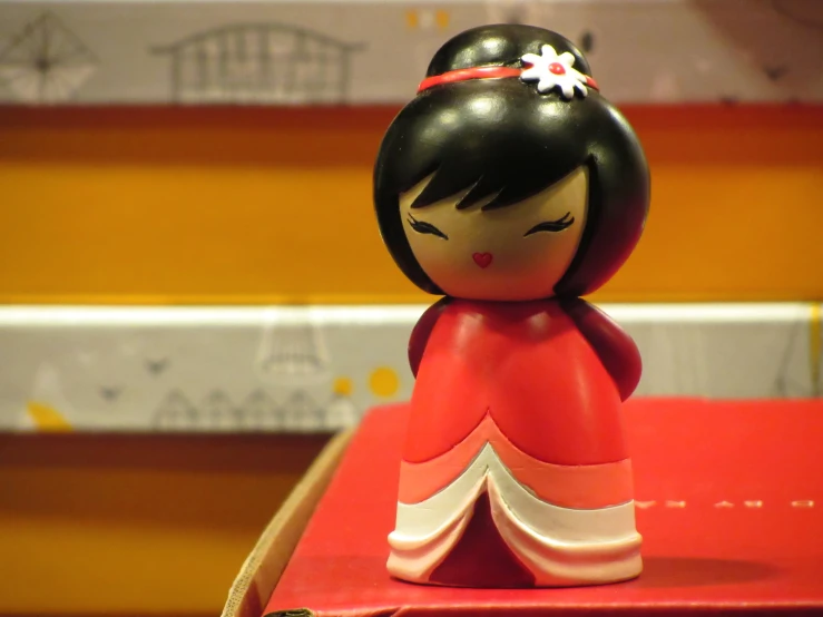 a toy figurine of a woman in an oriental dress