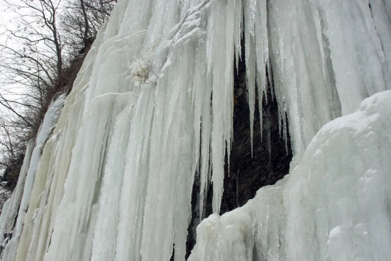 a bunch of ice that is hanging on the side of a mountain