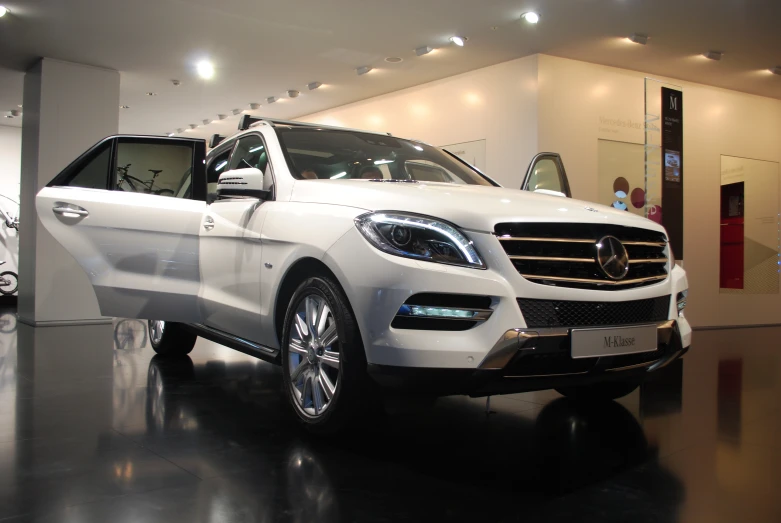 a white mercedes suv with its door open